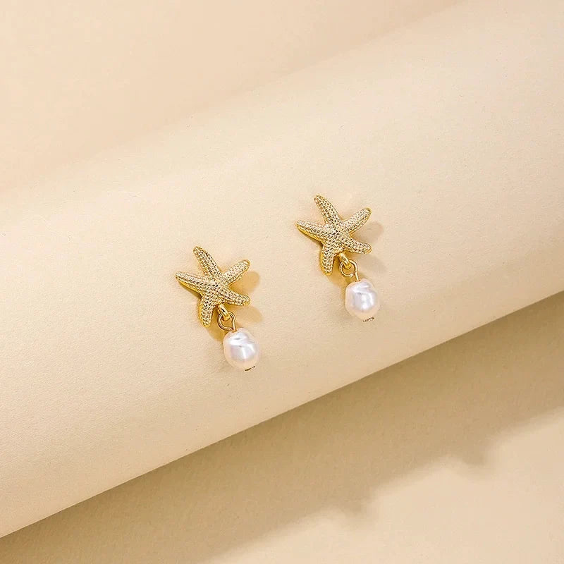 Gold-tone seashell, starfish, and pearl earrings