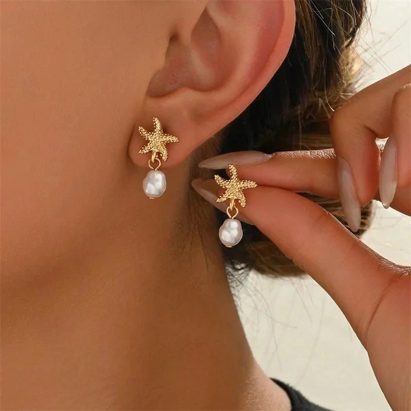 Gold-tone seashell, starfish, and pearl earrings