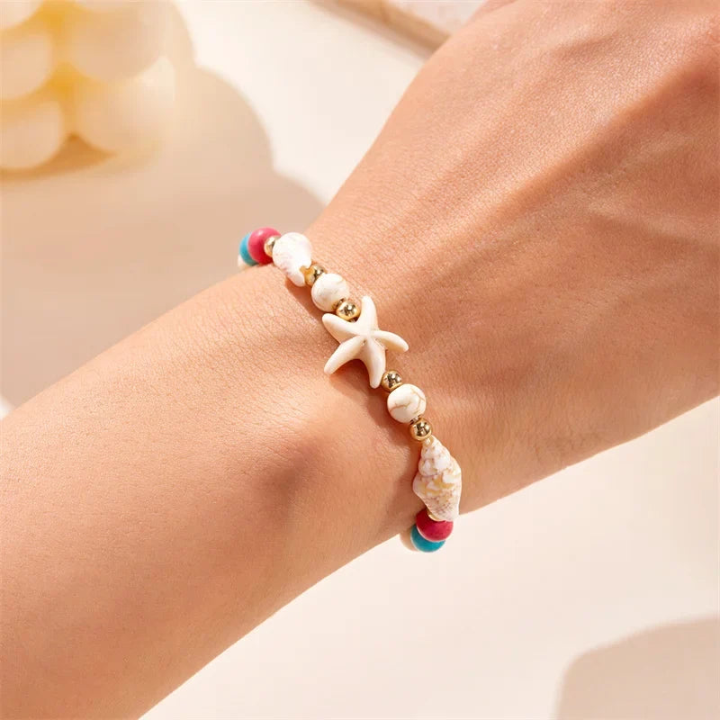 Cord bracelet with shell and red starfish star