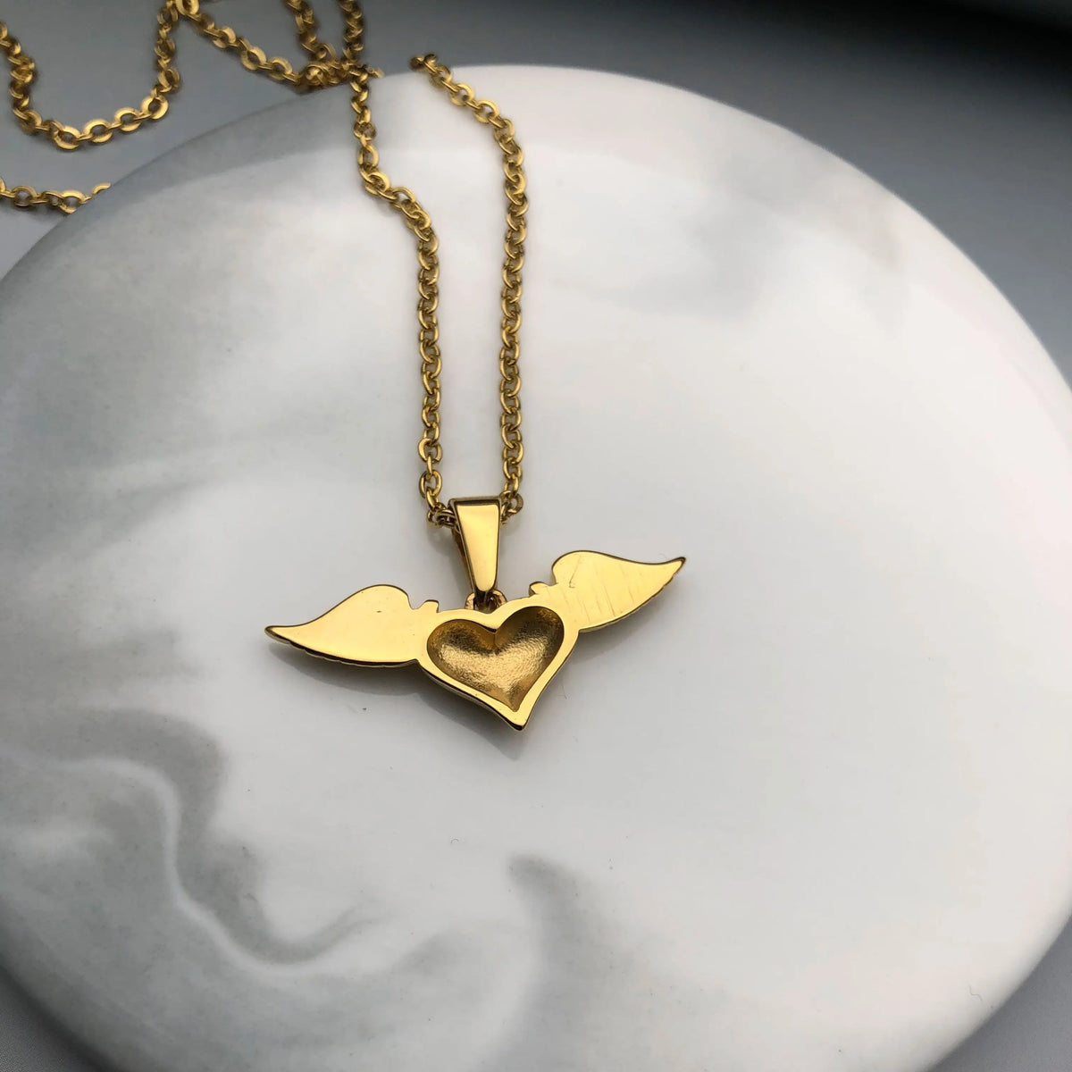 Necklace with angel wing and heart pendant