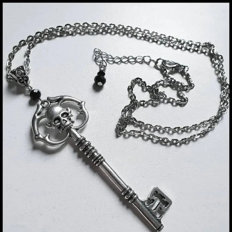 Necklace with key and skull pendant