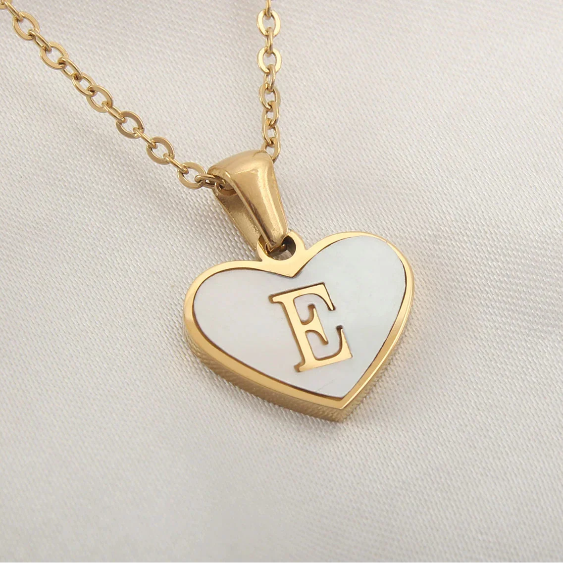 Necklace with white heart pendant initial e