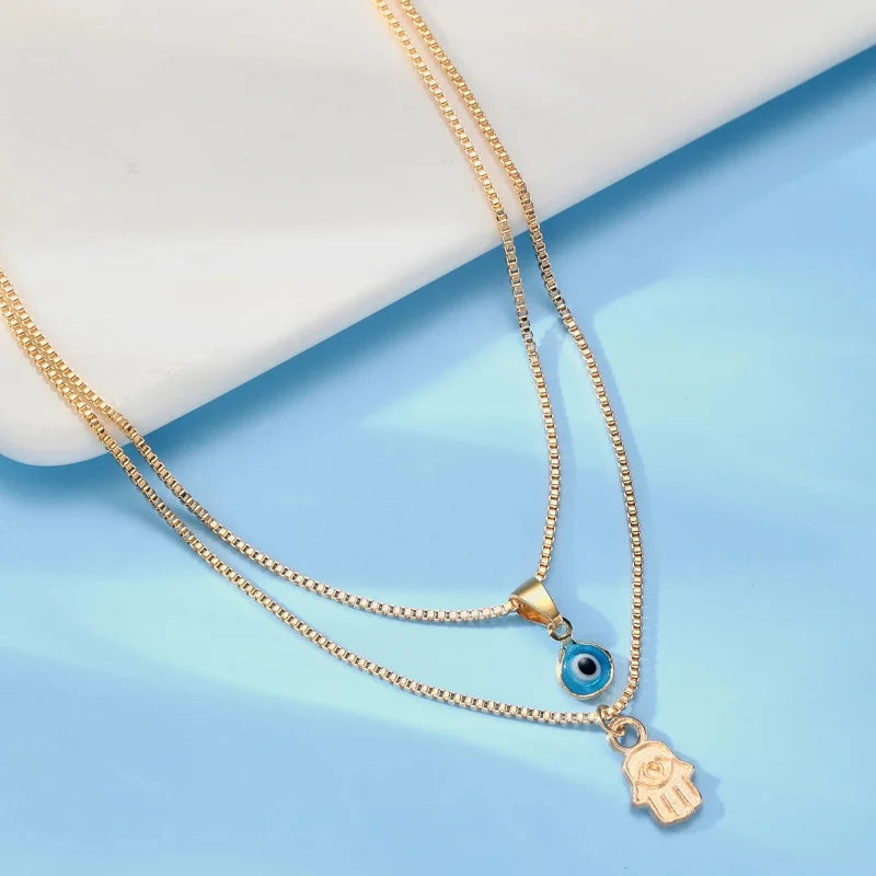 Collier Double avec Pendentif Oeil Bleu Turc et Main de Fatma or