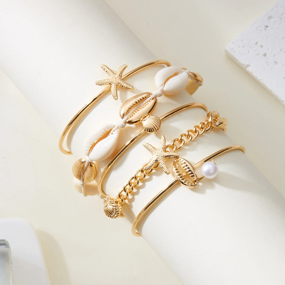 Set of 5 gold shell and star bracelets