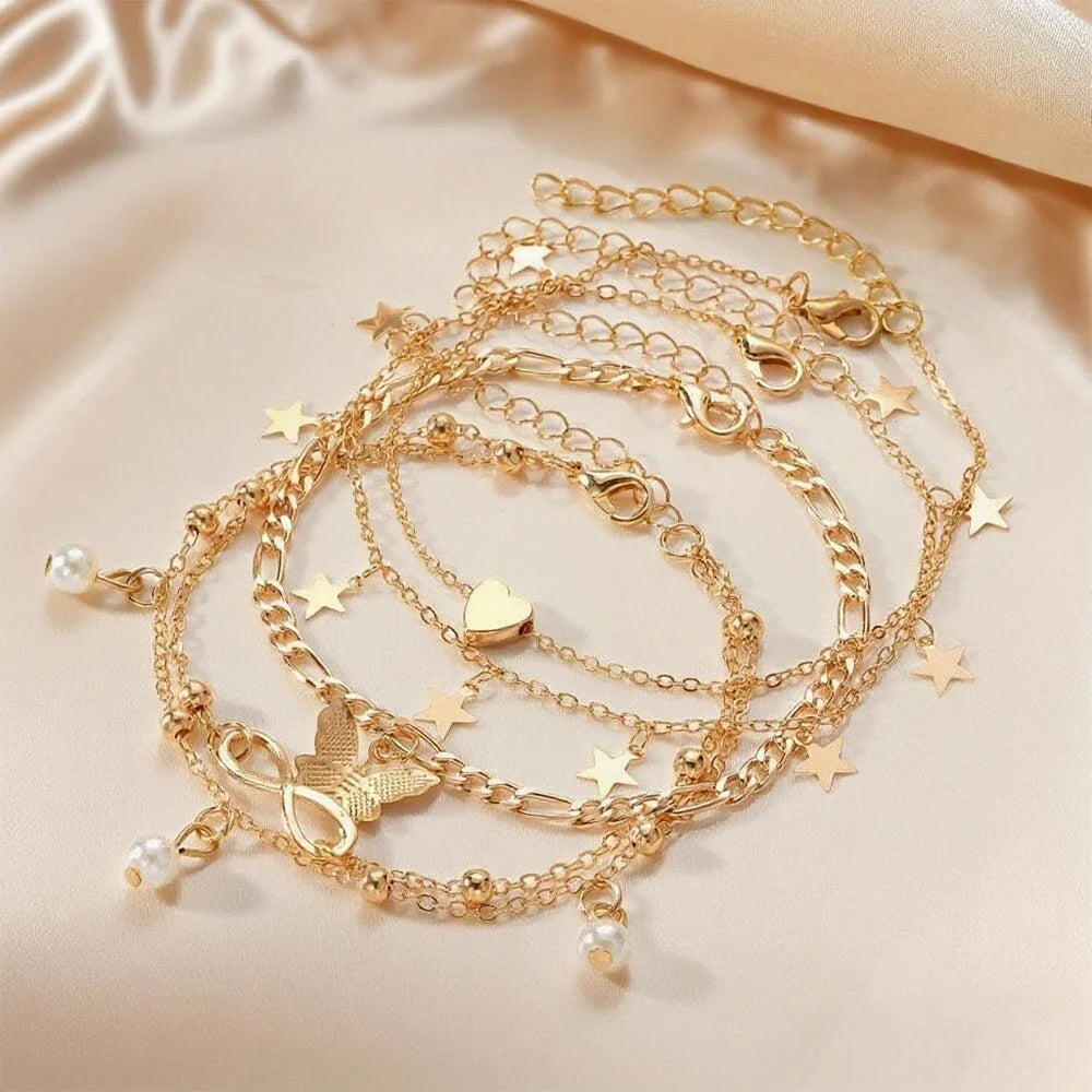 Set of 5 anklets: star, infinity, butterfly, beads, and heart
