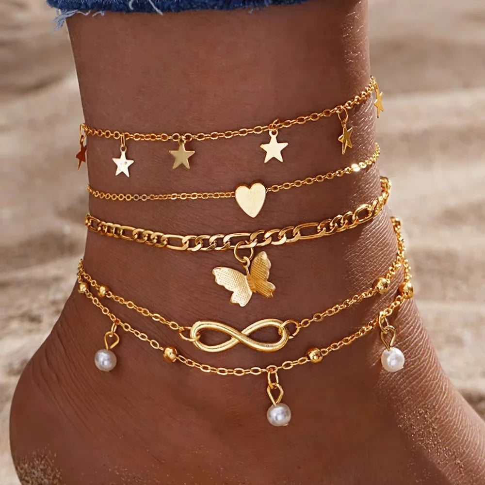 Set of 5 anklets: star, infinity, butterfly, beads, and heart